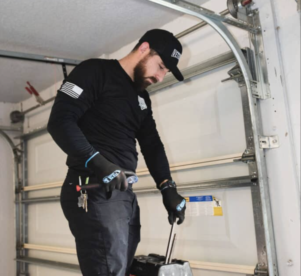 Sarasota Garage Door Repair Technician Mike Working On Fixing A Broken Spring